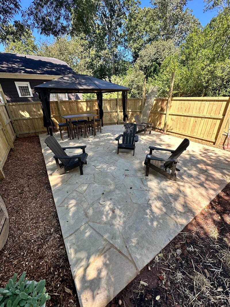 Elegant paver driveway and walkway leading to a North Atlanta home with mature landscaping