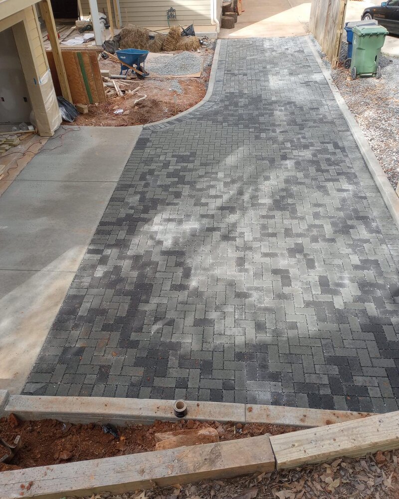 Permeable pavers driveway with concrete bend and curb.