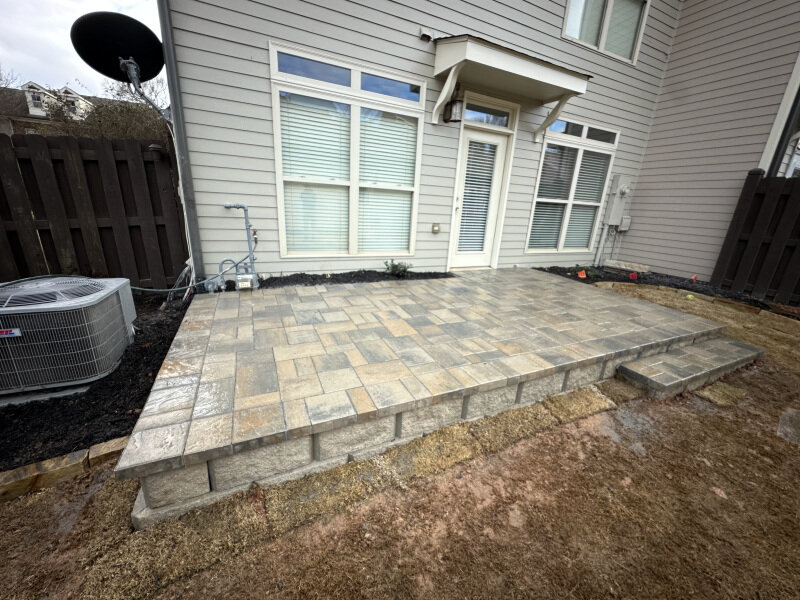 Elevated paver patio with retaining wall blocks in Canton, GA.