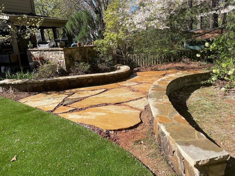 Natural stone walls, flagstone slabs pathway and steppingstones.